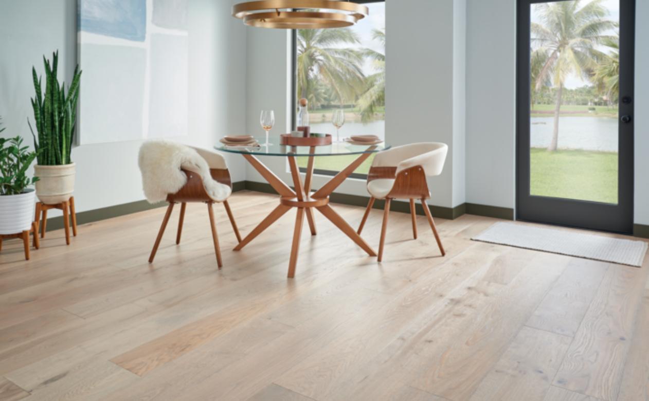 warm toned hardwood flooring in dining room with wood and glass table and wood chairs.